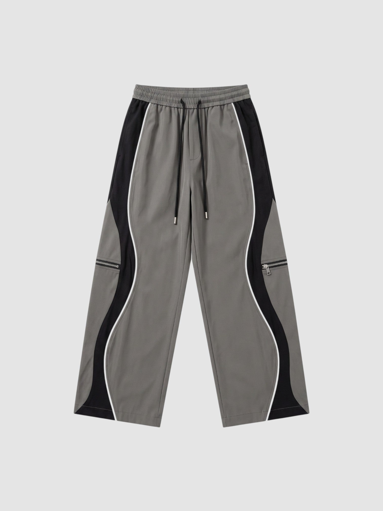 Y2K AVENUE grey and black panelled Y2K trousers with white piping, decorative zippers, and adjustable ankle cords.