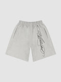 Y2K Avenue grey fleece shorts with black cursive calligraphy print, elastic waist, and side pockets.