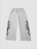 Y2K Avenue grey heather wide-leg joggers featuring black tribal graphic prints on the sides and an elastic waistband.