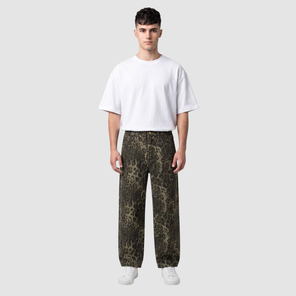 Y2K Avenue baggy leopard print denim jeans with a wide leg fit worn by a male model with a white t-shirt