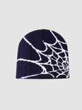 Y2K Avenue navy blue beanie with a white spider web graphic pattern in a lightweight polyester knit fabric.