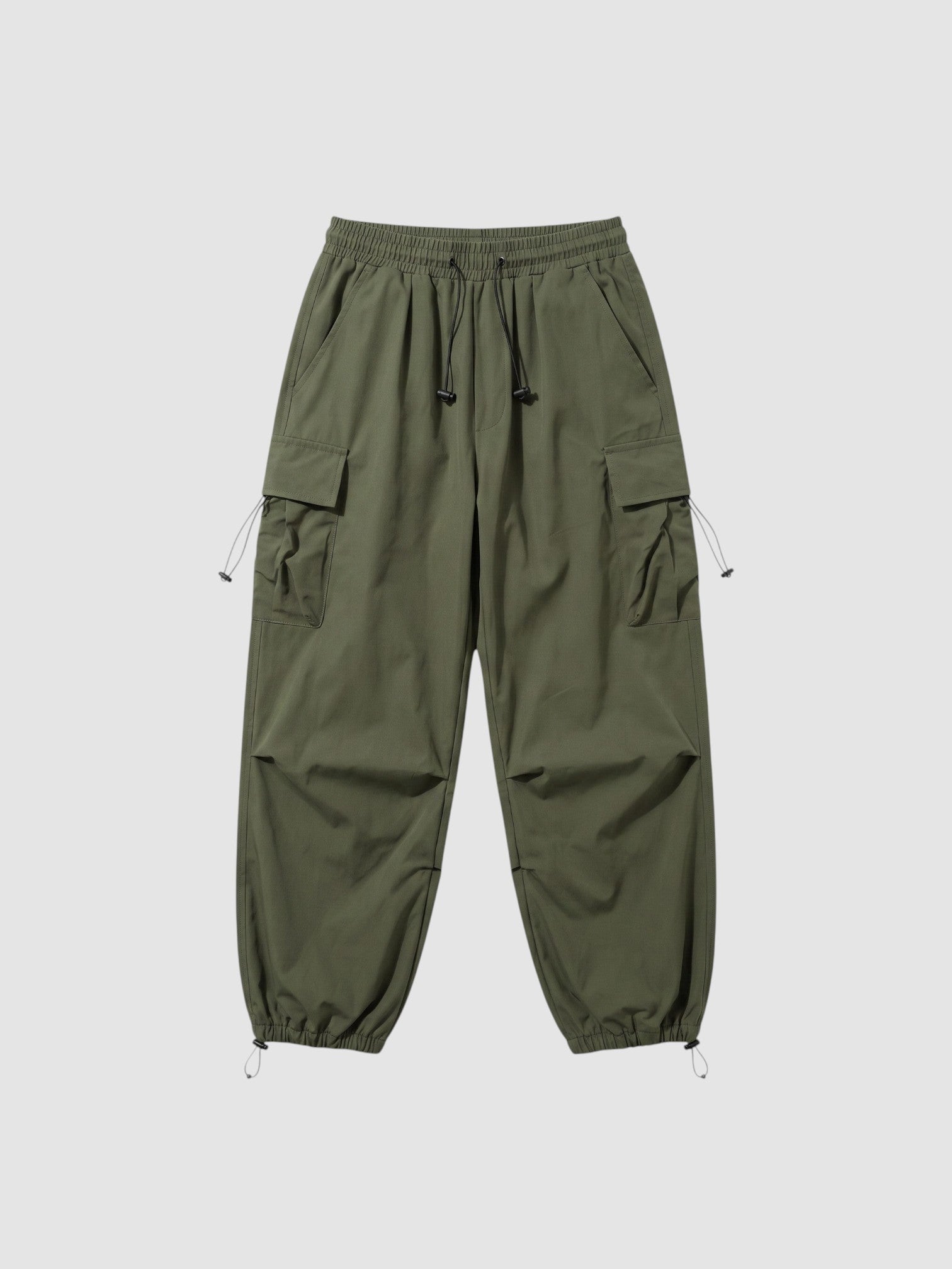 Y2K Avenue olive green parachute cargo pants with elastic waistband, side flap pockets, and adjustable leg cords.