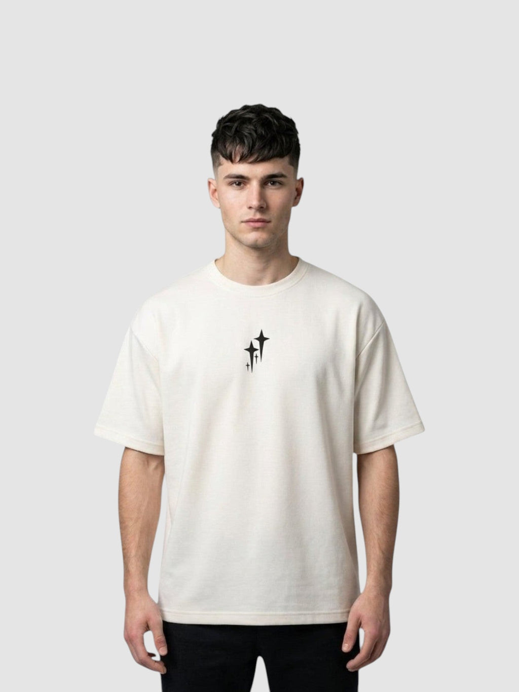 Y2K Avenue oversized cream t-shirt with chrome star graphic, ribbed crew neck, and drop shoulders on a male model.