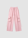 Y2K Avenue powder pink parachute cargo pants with wide legs, elastic waist, drawstring, and side flap pockets.