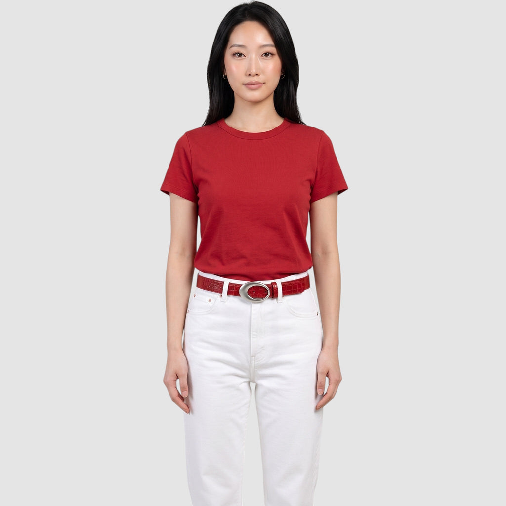 Y2K AVENUE red faux crocodile leather belt with a silver oval buckle worn by a model in a red t-shirt and white jeans
