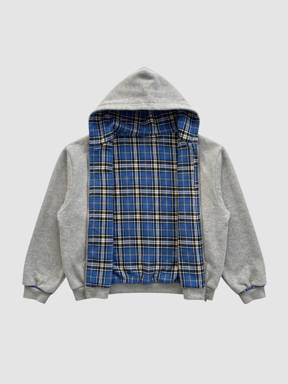 Y2K AVENUE reversible zip-up hoodie featuring a grey cotton fleece exterior and a blue tartan plaid interior lining.