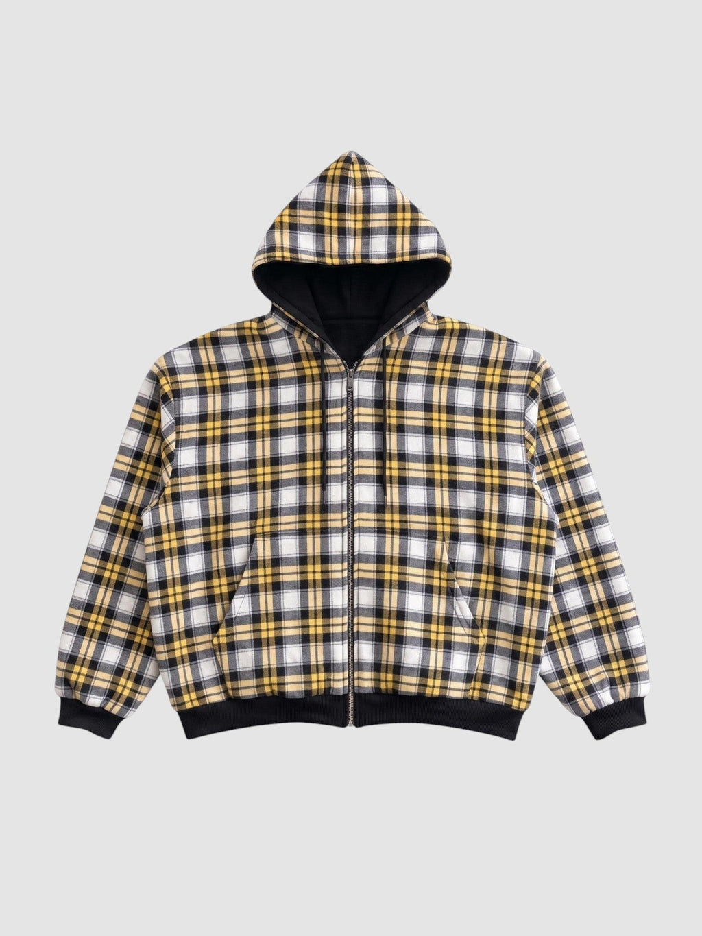 Y2K AVENUE reversible zip-up hoodie featuring a yellow, white, and black plaid pattern with black ribbed cuffs.