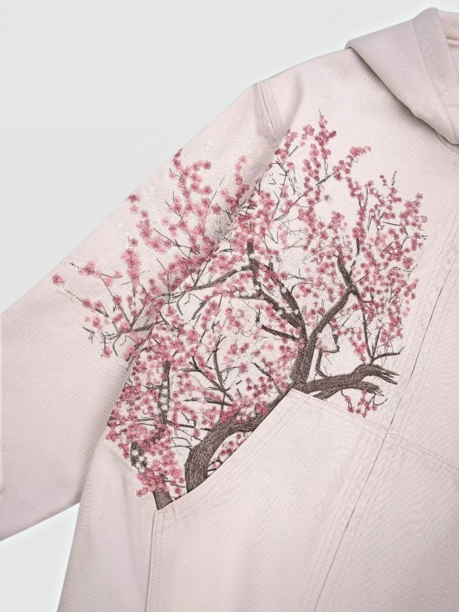 Y2K Avenue Sakura zip-up hoodie in faded powder pink cotton with an asymmetrical cherry blossom branch print