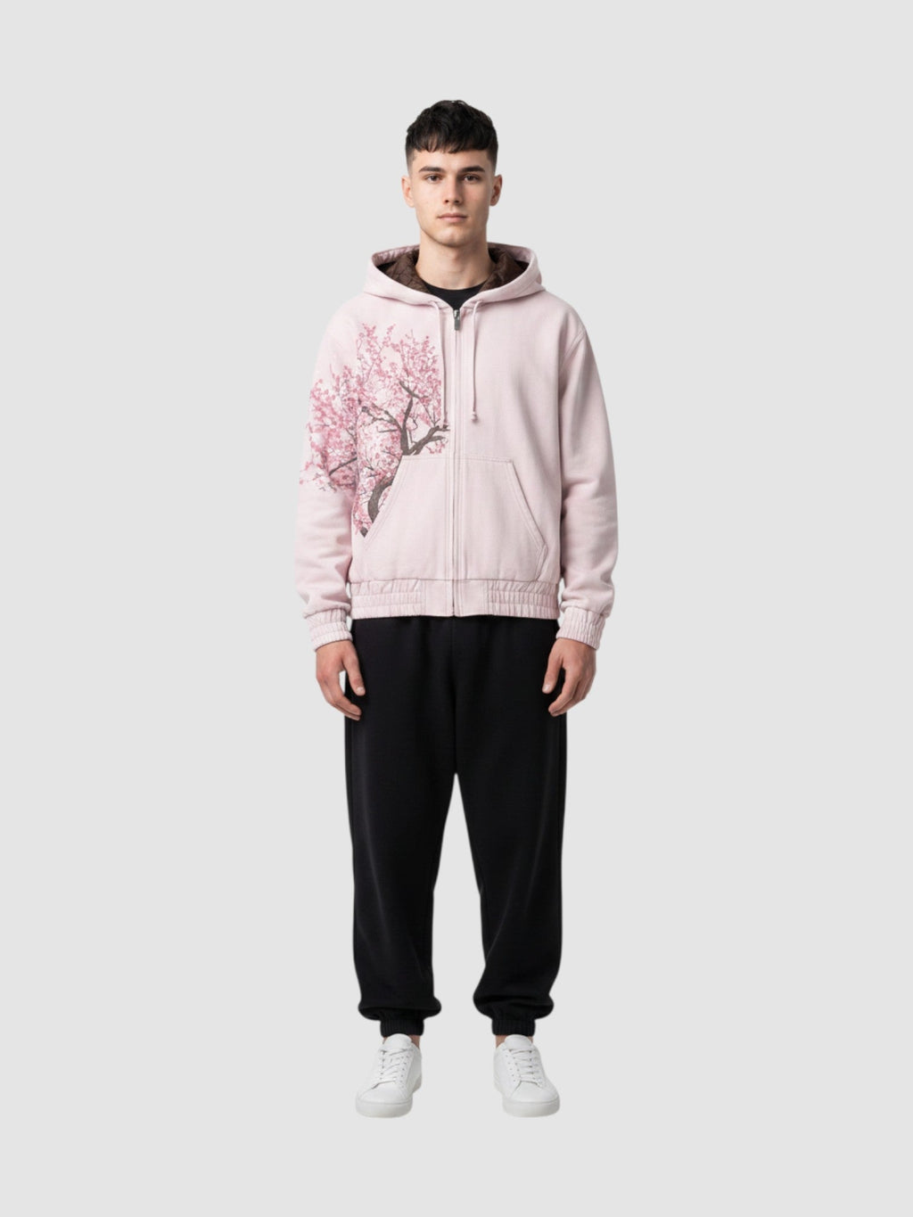 Y2K Avenue Sakura zip-up hoodie in faded powder pink cotton with an asymmetrical cherry blossom print on the side.