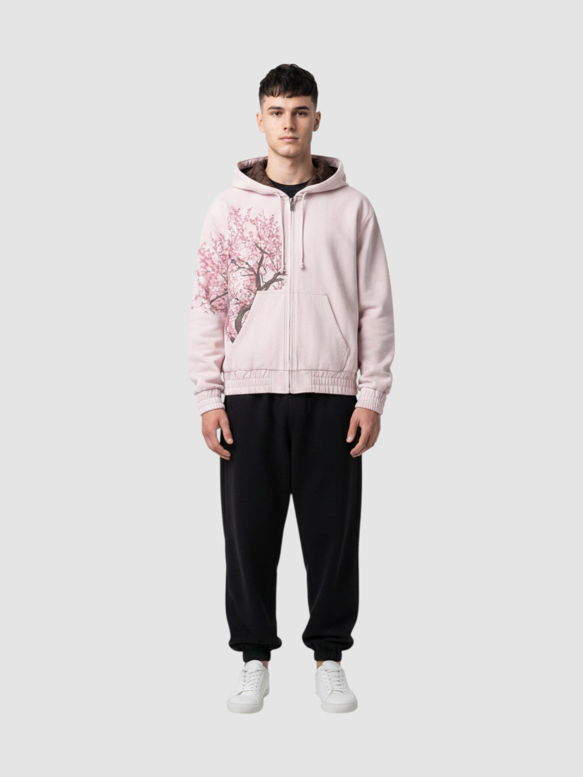 Y2K Avenue Sakura zip-up hoodie in faded powder pink cotton with an asymmetrical cherry blossom print on the side.