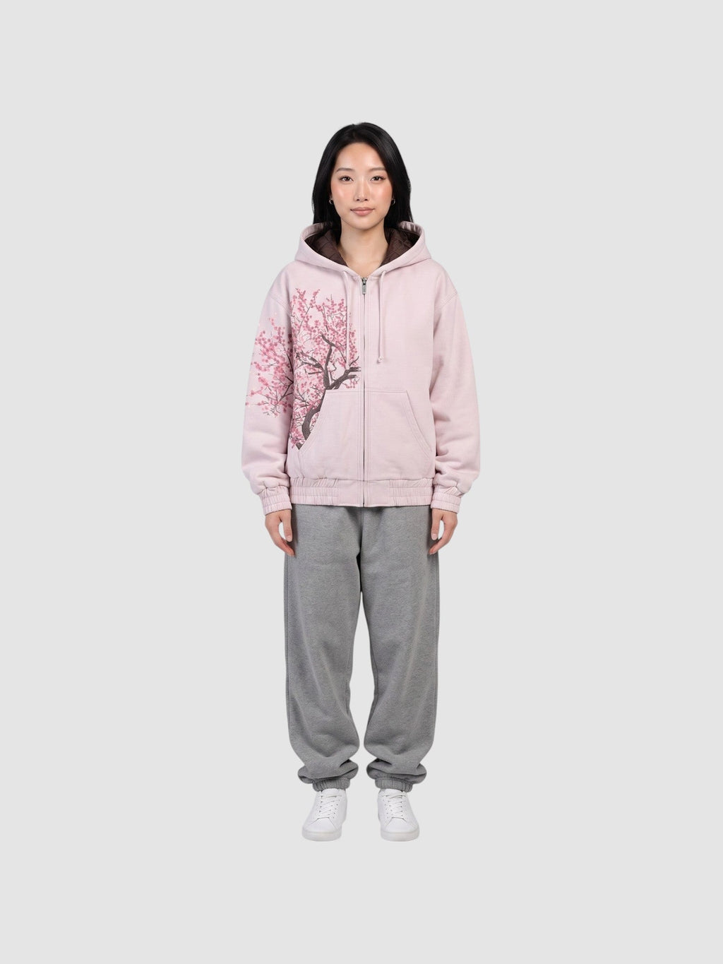 Y2K Avenue Sakura zip-up hoodie in faded powder pink cotton with an asymmetrical cherry blossom print and boxy fit.