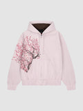 Y2K Avenue Sakura zip-up hoodie in faded powder pink cotton with an asymmetrical cherry blossom print and dark lining.