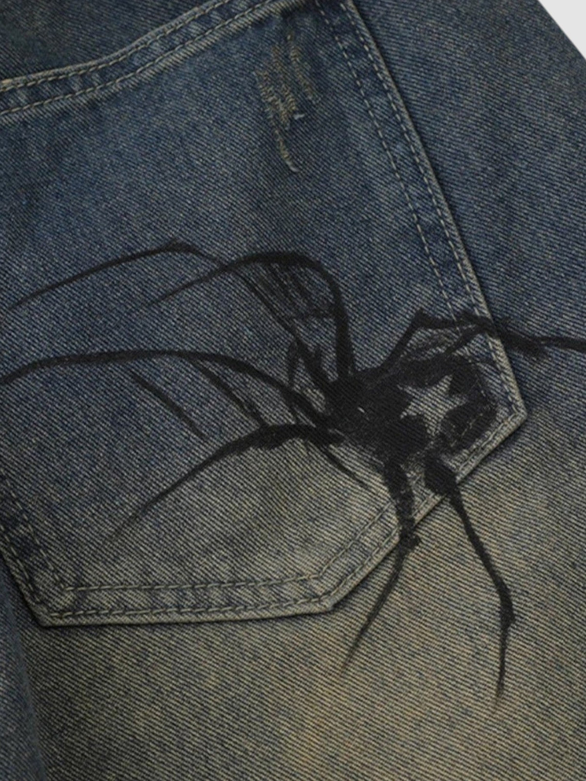 Y2K AVENUE blue distressed denim jorts featuring a detailed black spider graphic printed on the back pocket