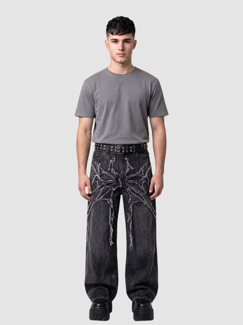 Y2K Avenue wide-leg acid wash black denim jeans with raw-edge spiderweb fabric appliqués radiating from the waist.