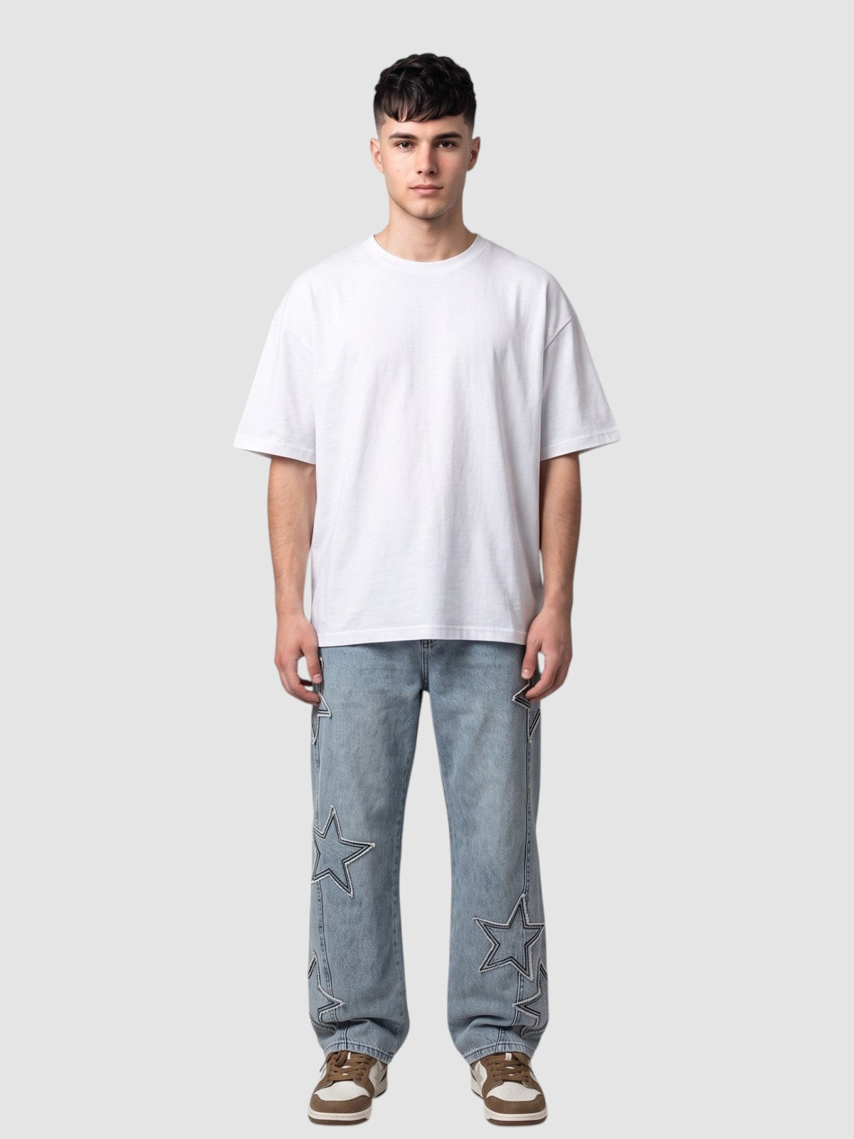 Y2K AVENUE light blue denim jeans with raw-edge star appliqués worn by a man with a white t-shirt and sneakers.