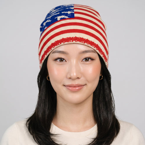 Y2K Avenue USA flag beanie with stars and stripes pattern worn by a model on a light grey background