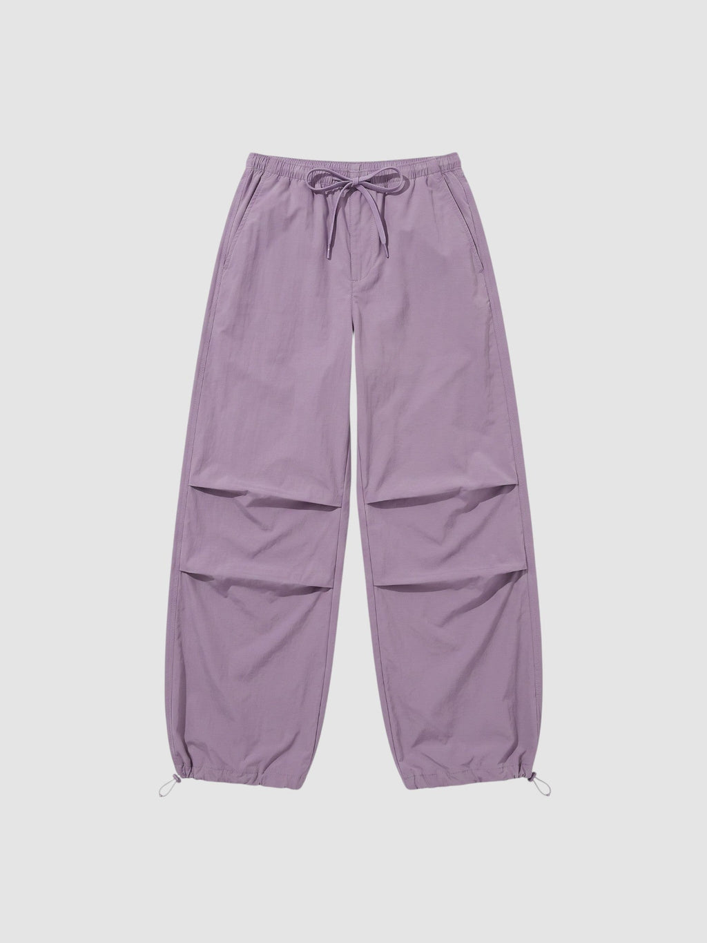 Y2K Avenue high-waisted violet parachute pants in matte nylon with adjustable drawstring waist and ankle cuffs.
