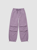 Y2K Avenue high-waisted violet parachute pants in matte nylon with adjustable drawstring waist and ankle cuffs.