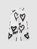 Y2K Avenue white wide-leg pants featuring black spray-painted heart motifs and an elastic drawstring waist.