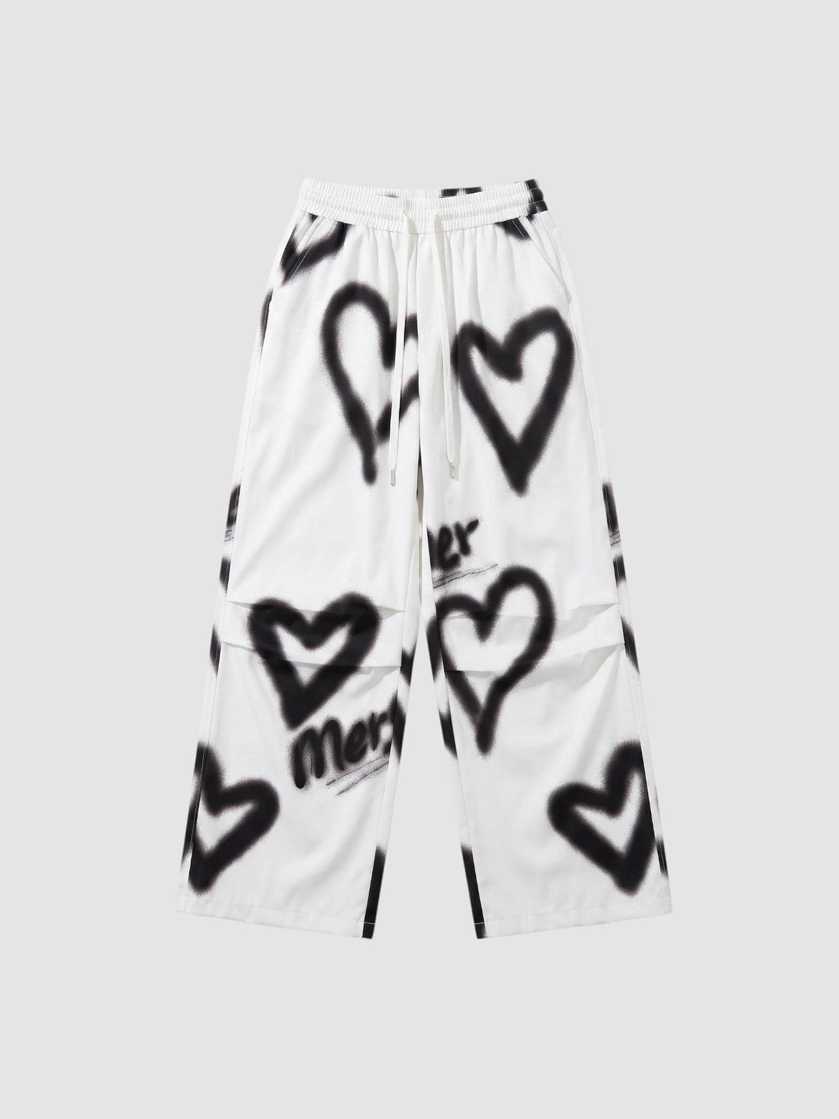 Y2K Avenue white wide-leg pants featuring black spray-painted heart motifs and an elastic drawstring waist.