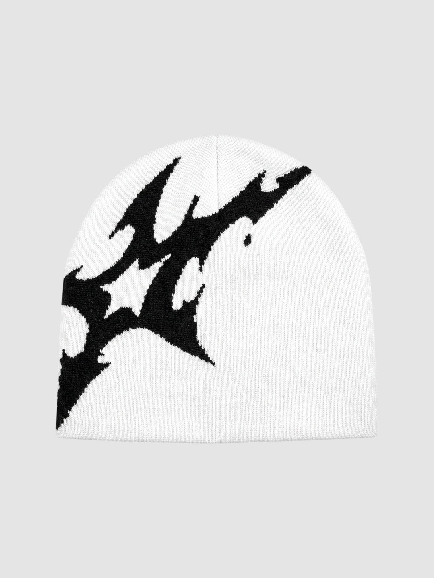 Y2K Avenue white acrylic beanie featuring an asymmetrical black lightning bolt graphic pattern