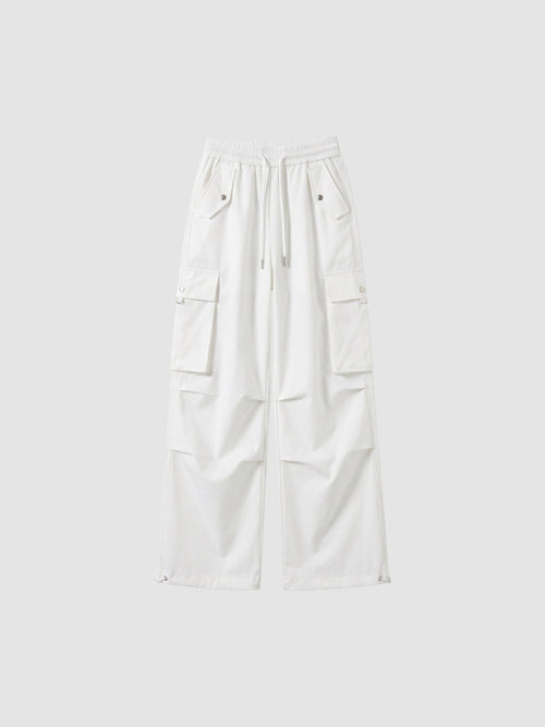 Y2K Avenue white high-waisted parachute cargo pants in matte poplin with multiple pockets and adjustable leg cords.