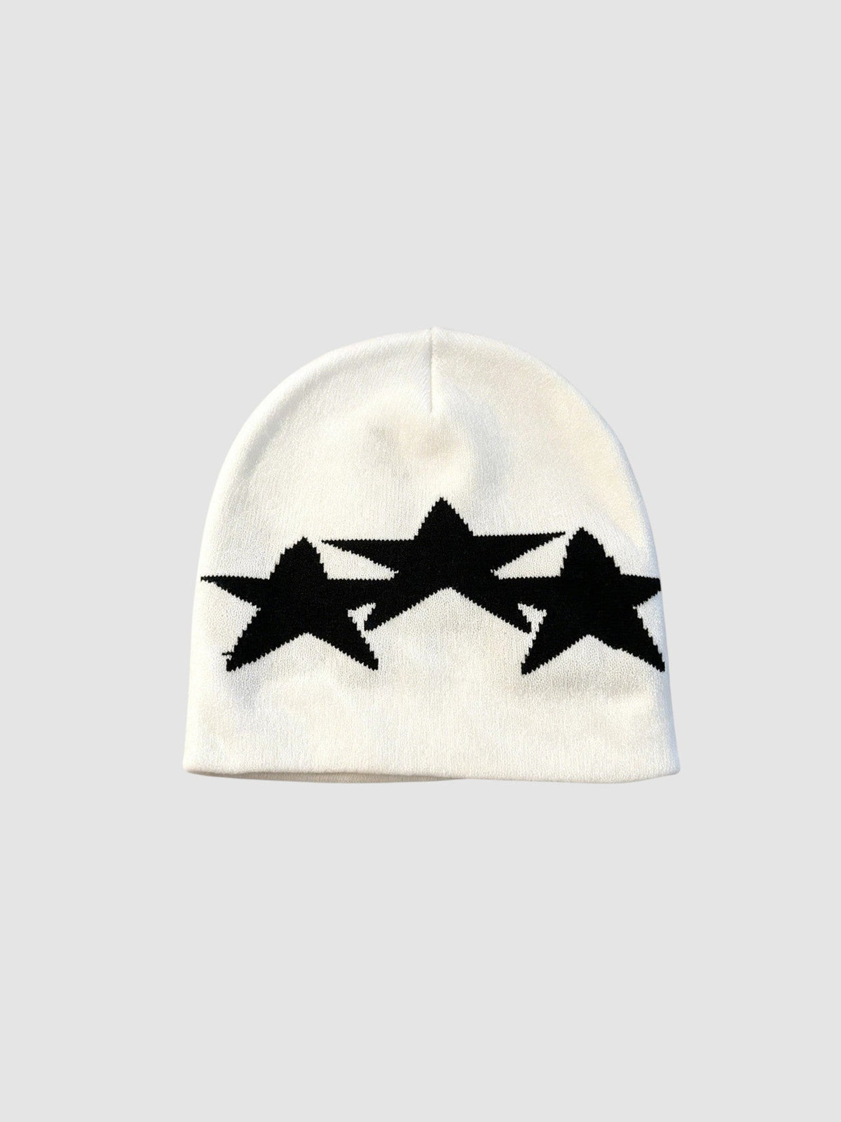 Y2K Avenue white acrylic beanie featuring three overlapping black star motifs in a graphic Y2K style
