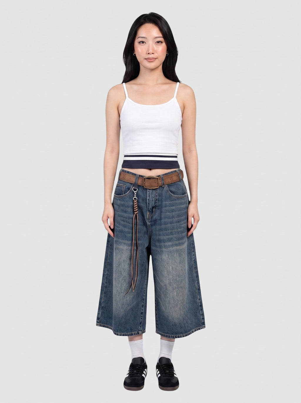 Y2K Avenue model wearing wide-leg denim bermuda shorts with a faded wash, high waist, and brown leather belt.