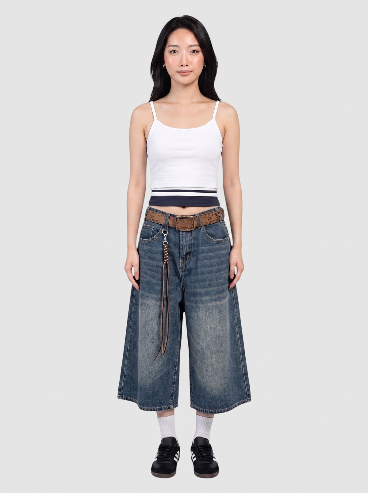 Y2K Avenue model wearing wide-leg denim bermuda shorts with a faded wash, high waist, and brown leather belt.