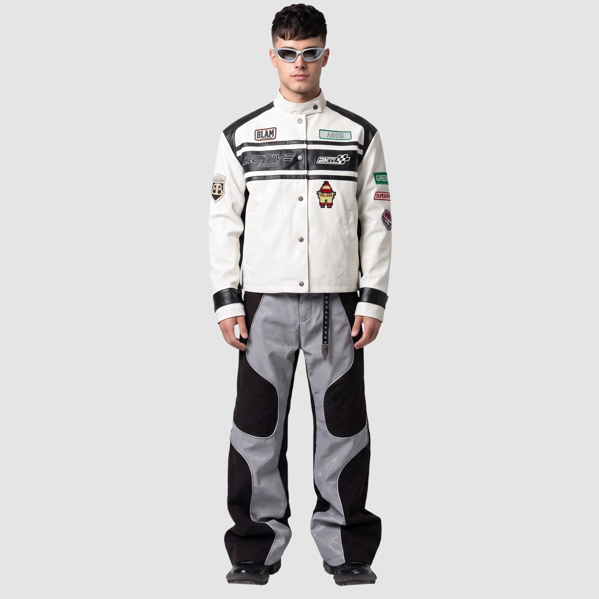 Y2K AVENUE wide leg faux leather pants with wavy grey and black panels and white piping worn by a male model